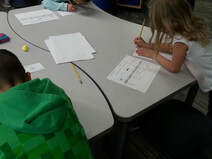 Photo of young writers engaged in a writing activity during Roxanne Troup's school visit.