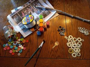 craft materials including buttons, washers, metal nuts, soda pop tabs, paint, and fishing line